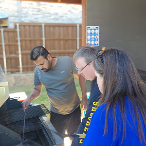 CEO Evan and COO Kimilee fired up the grill for the team, with help from Content Manager Troy.
